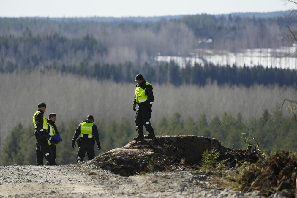 Finland's border guards stay at construction site of the border barrier fence between Finland and Russia near Pelkola border crossing point in Imatra, south-eastern Finland, Friday, April 14, 2023. (AP Photo/Sergei Grits)