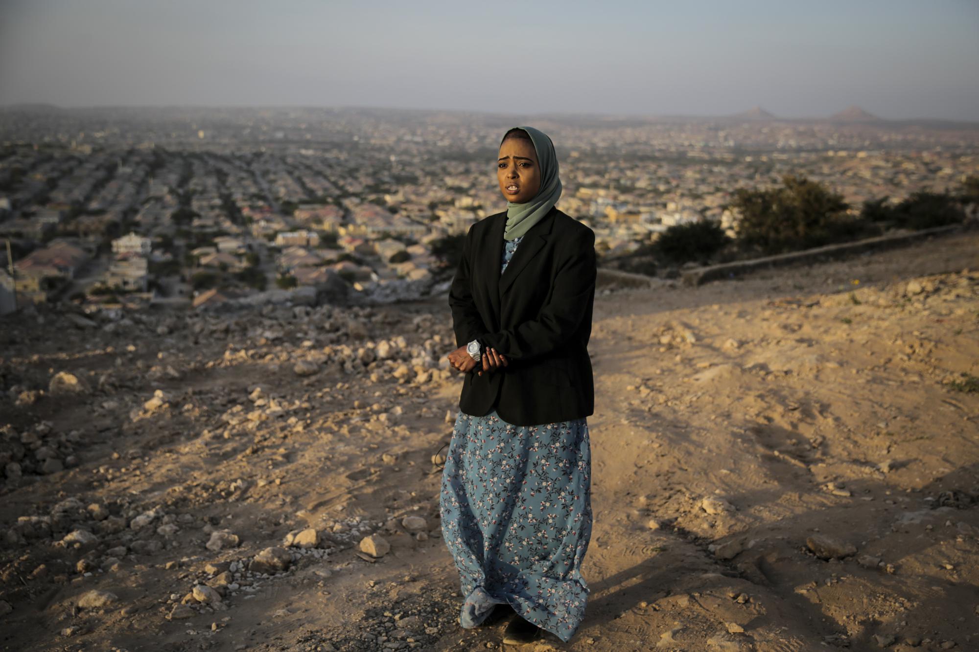 Nurse Hana Ismail, who was moved to write a poem with the words "I have a mark that can never be erased" describing the practice of having to take a knife to the scars resulting from female genital mutilation (FGM) to open the way for women in labor, prepares to be interviewed in Hargeisa, Somaliland, a semi-autonomous breakaway region of Somalia, Tuesday, Feb. 8, 2022. Officials and health workers say cases of female genital mutilation increased during the pandemic in parts of Africa and particularly in Somaliland where 98 percent of girls aged 5 to 11 undergo the procedure. (AP Photo/Brian Inganga)