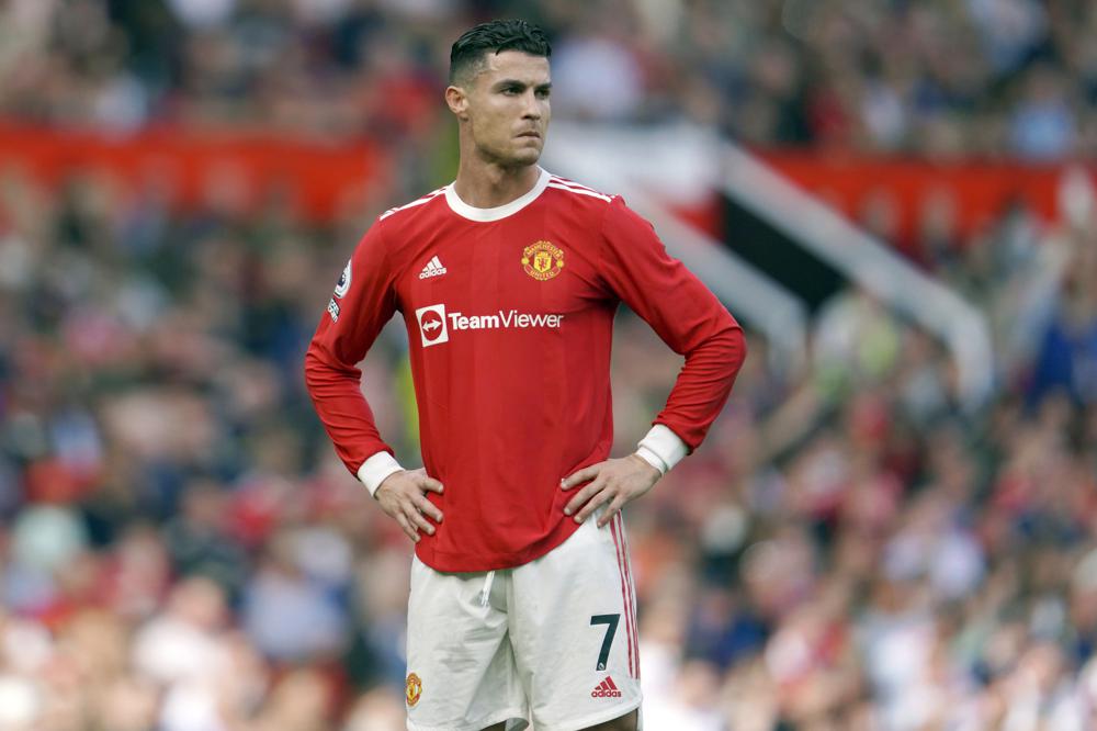 FILE- Manchester United's Cristiano Ronaldo stands on the pitch during the English Premier League soccer match between Manchester United and Norwich City at Old Trafford stadium in Manchester, England, on April 16, 2022. A Nevada woman has lost her bid in a U.S. court to force international soccer star Cristiano Ronaldo to pay millions of dollars more than the $375,000 in hush money she received after claiming he raped her in Las Vegas in 2009.  (AP Photo/Jon Super, File)