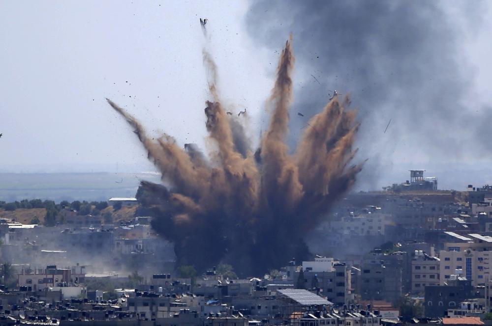 File - In this May 13, 2021, file photo, smoke rises following Israeli airstrikes on a building in Gaza City. Human Rights Watch on Tuesday, July 27, 2021, accused the Israeli military of carrying attacks that "apparently amount to war crimes" during an 11-day war against the Hamas militant group in May. (AP Photo/Hatem Moussa, File)