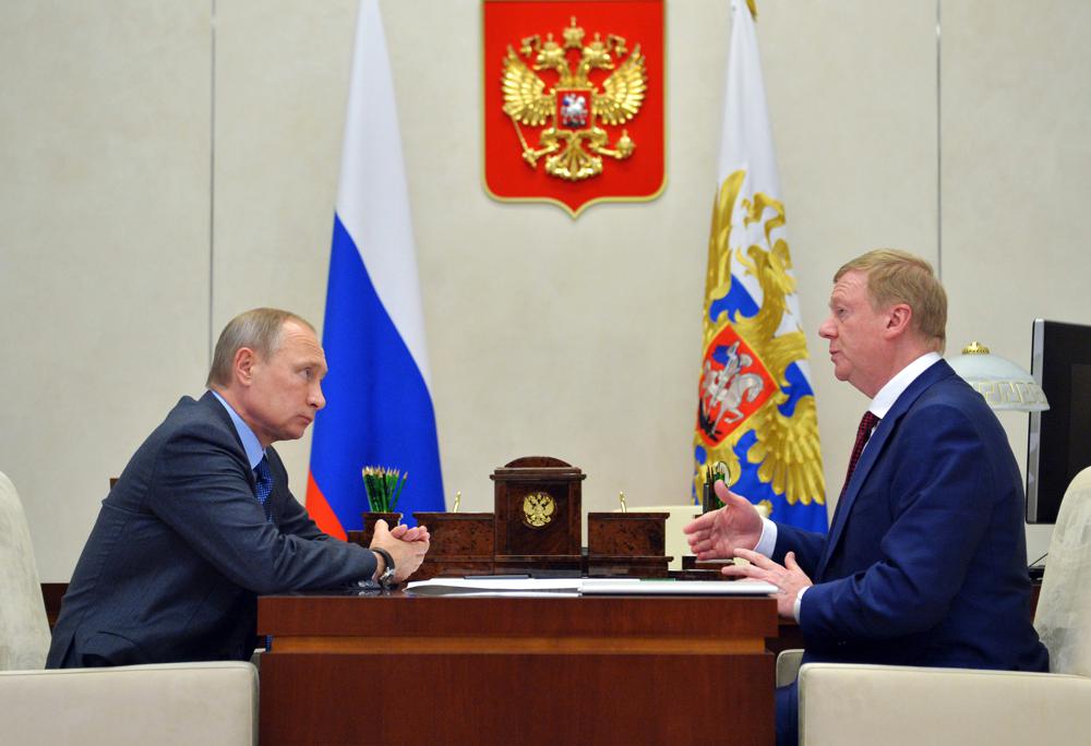 FILE - Russian President Vladimir Putin, left, listens to RUSNANO CEO Anatoly Chubais in the Novo-Ogaryovo residence, outside Moscow, Russia, Monday, Nov. 7, 2016. The resignation of Chubais, who was Putin's envoy to international organizations for sustainable development, was not the first resignation of a state official over the war with Ukraine, but it was one of the most striking. (AP Photo)