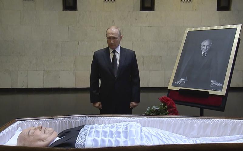 In this image taken from video provided by the Russian pool television on Thursday, Sept. 1, 2022, Russian President Vladimir Putin pays his last respect near the coffin of former Soviet President Mikhail Gorbachev at the Central Clinical Hospital in Moscow Russia. (Russian pool via AP)