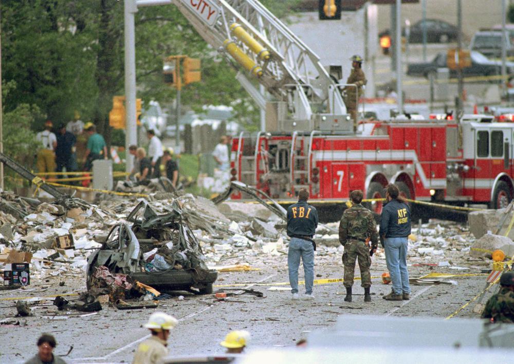 FILE - In this April 19, 1995, file photo, Federal Alcohol, Tobacco and Firearms agents and FBI agents survey the damage to the Alfred P. Murrah Federal Building, following a car bomb blast in Oklahoma City, Okla. Rescuers who responded to past disasters say the search for victims of the Florida condo collapse that occurred on June 24, 2021, brought back memories of the Oklahoma City bombing and the Sept. 11 attacks. (AP Photo/Rick Bowmer, File)