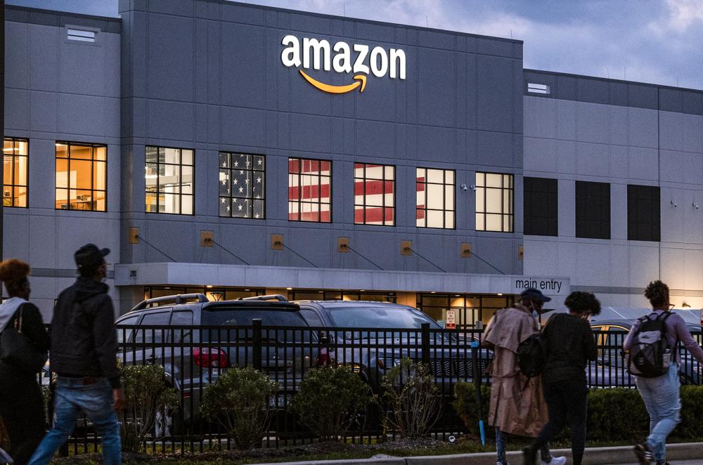 FILE - People arrive for work at the Amazon distribution center in the Staten Island borough of New York, on Oct. 25, 2021. Amazon plans to file objections to the union election on Staten Island, N.Y., that resulted in the first successful U.S. organizing effort in the company’s history. The e-commerce giant stated its plans in a legal filing to the National Labor Relations Board made public Thursday, April 7, 2022. (AP Photo/Craig Ruttle, File)