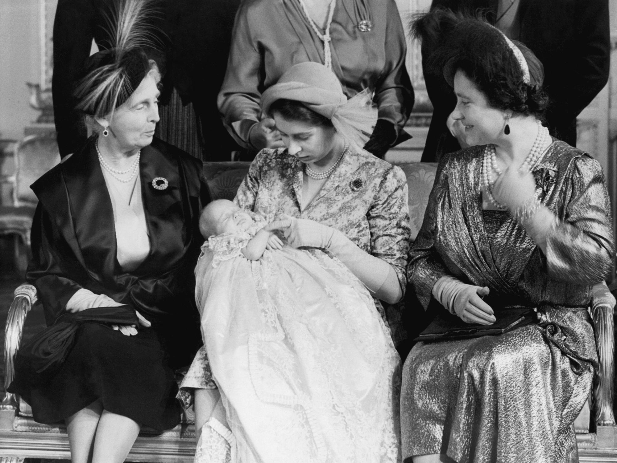 FILE - Britain's Princess Elizabeth, holds her daugher Princess Anne after her christening, at Buckingham Palace, in London, Oct. 23, 1950. Queen Elizabeth II, Britain’s longest-reigning monarch and a rock of stability across much of a turbulent century, has died. She was 96. Buckingham Palace made the announcement in a statement on Thursday Sept. 8, 2022. (AP Photo, File)