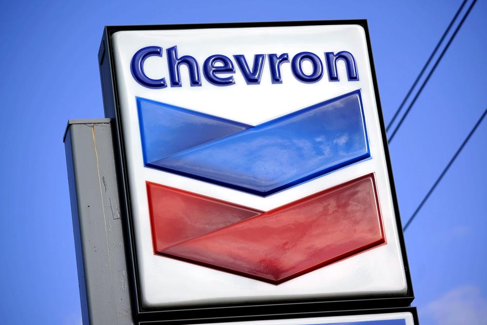 FILE - A Chevron sign is displayed outside one of the company's gas stations in Bradenton, Fla., Feb. 22, 2022. The Biden administration is easing some oil sanctions on Venezuela in an effort to support newly restarted negotiations between the Venezuelan government and its opposition. The Treasury Department is allowing Chevron to resume “limited” energy production in Venezuela after years of sanctions that have dramatically curtailed oil and gas profits that have flowed to President Nicolás Maduro’s government. (AP Photo/Gene J. Puskar, File)