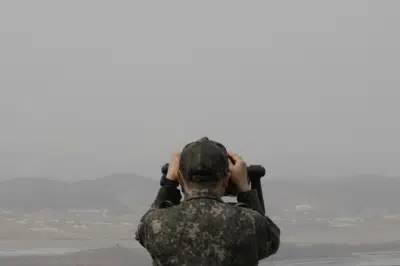 A South Korean army soldier watches the North Korea side from the Unification Observation Post in Paju, South Korea, near the border with North Korea, Friday, March 24, 2023. North Korea said Friday its cruise missile launches this week were part of nuclear attack simulations that also involved a detonation by a purported underwater drone as leader Kim Jong Un vowed to make his rivals "plunge into despair." (AP Photo/Ahn Young-joon)