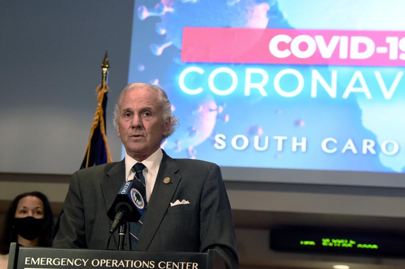 FILE - In this July 29, 2020 file photo, South Carolina Gov. Henry McMaster speaks during a COVID-19 briefing as state epidemiologist Linda Bell, left, looks on, in West Columbia, S.C. McMaster ended South Carolina’s ongoing pandemic-related state of emergency on Monday, June 7, 2021. The Republican said during a news conference that the coronavirus situation in the state had improved to the point that it was no longer necessary.  (AP Photo/Meg Kinnard, File)