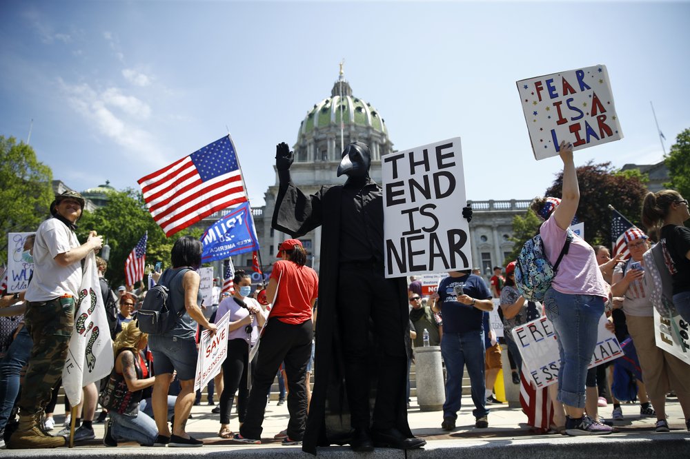 FILE - In this Friday, May 15, 2020 file photo, protesters hold a rally against Pennsylvania's coronavirus stay-at-home order at the state Capitol in Harrisburg, Pa. (AP Photo/Matt Rourke)