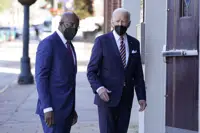 FILE - President Joe Biden and Sen. Raphael Warnock, D-Ga., enter Ebenezer Baptist Church, Jan. 11, 2022, in Atlanta. Warnock is senior pastor at the church. With Warnock having secured his first full term and Biden buoyed by Democrats' better-than-expected election results, the senator is welcoming the president back to Georgia and to America's most famous Black church. (AP Photo/Patrick Semansky, File)