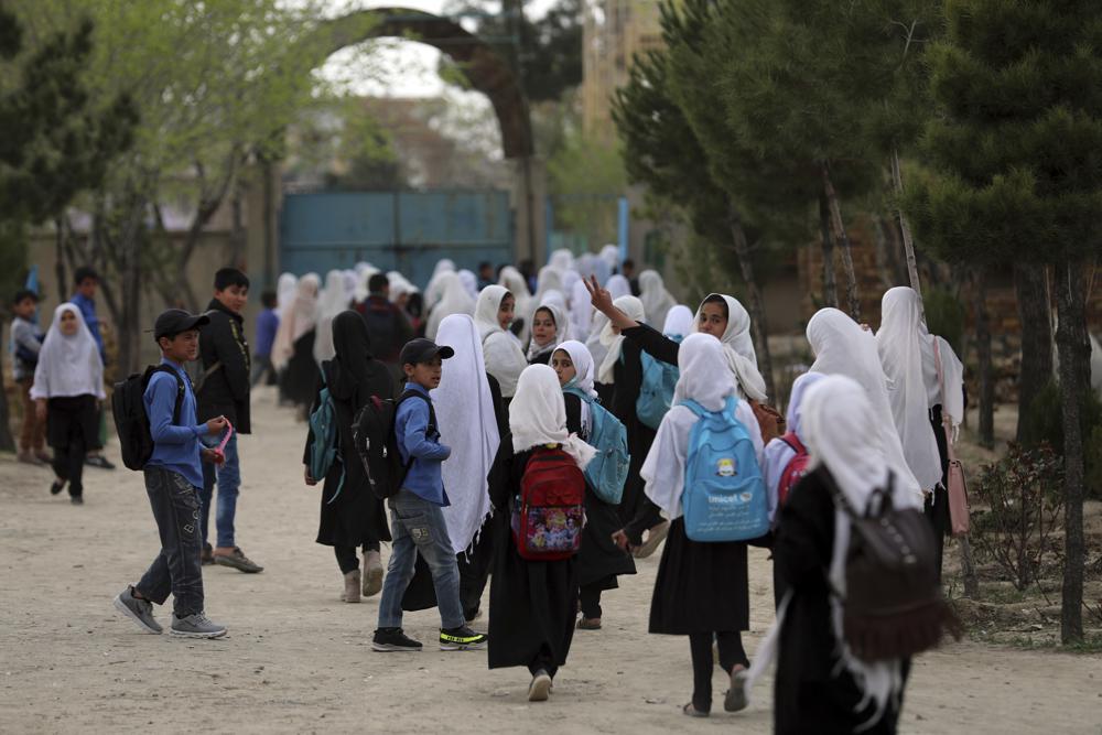 FILE - Afghan students leave school classes in a primary school in Kabul, Afghanistan on March 27, 2021. In a surprise decision the hardline leadership of Afghanistan's new rulers has decided against opening educational institutions to girls beyond Grade six, a Taliban official said Wednesday, March 23, 2022 on the first day of Afghanistan's new school year. (AP Photo/Rahmat Gul, File)