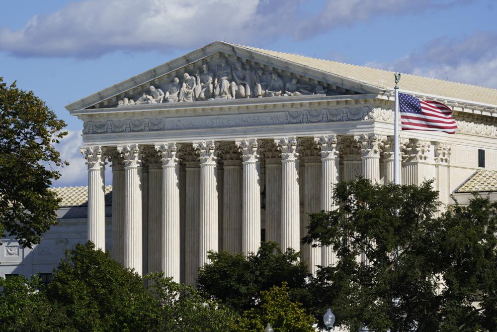 In this Oct. 18, 2021 photo, the Supreme Court is seen in Washington. Texas is urging the Supreme Court to leave in place its law banning most abortions and telling the justices there’s no reason to rush into the case. The state filed its response Thursday to the Biden administration’s call on the high court to block the law and rule conclusively this term on the measure’s constitutionality. (AP Photo/J. Scott Applewhite)