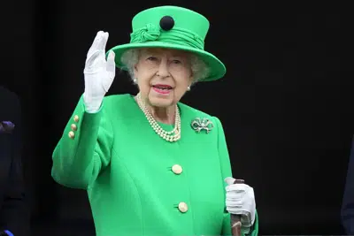 FILE - Britain's Queen Elizabeth II waves to the crowd during the Platinum Jubilee Pageant at the Buckingham Palace in London, June 5, 2022, on the last of four days of celebrations to mark the Platinum Jubilee. Queen Elizabeth II's death in September 2022 was arguably the most high-profile death this year. In her 70 years on the British throne, she helped modernize the monarchy across decades of enormous social change, royal marriages and births, and family scandals. For most Britons, she was the only monarch they had ever known. (AP Photo/Frank Augstein, Pool)