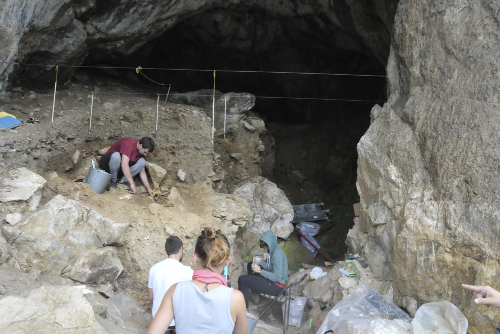 In this photo provided by Bence Viola in October 2022, researchers excavate a cave in the mountains of Siberia, Russia. In a study published Wednesday, Oct. 19, 2022, in the journal Nature, researchers were able to pull DNA out of tiny bone fragments found in two Russian caves, and used the genetic data to map out relationships between 13 different Neanderthals for clues to how they lived. (Bence Viola via AP)
