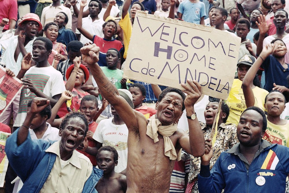 FILE - In this Feb. 11, 1990 file photo, Nelson Mandela's release from prison in Cape Town, is celebrated in Soweto, South Africa. Mandela's release set off joyous celebrations and violent clashes as supporters welcomed Mandela back from 27 years in jail. Tuesday, Feb. 11, 2020 marks the 30 year anniversary of the release of the former South African president. (AP Photo/Raymond Preston/File)