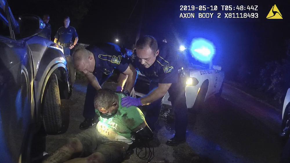 This image from video from Louisiana state police state trooper Dakota DeMoss' body-worn camera, shows troopers holding up Ronald Greene before paramedics arrived on May 10, 2019, outside of Monroe, La. The video obtained by The Associated Press shows Louisiana state troopers stunning, punching and dragging the Black man as he apologizes for leading them on a high-speed chase, footage authorities refused to release in the two years since Greene died in police custody. (Louisiana State Police via AP)