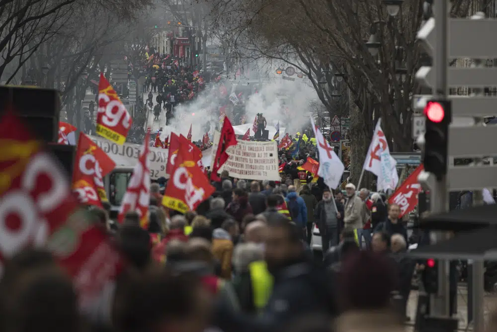 FILE - Protesters march during a demonstration against Macron's pension reform plan in Marseille, Thursday March 5, 2020. French workers angry over proposed changes to retirement rules are halting high-speed trains, disrupting electricity supplies and taking to the streets on Thursday, Jan. 19, 2023, in a day of nationwide strikes and protests seen as a major test for Emmanuel Macron and his presidency. (AP Photo/Daniel Cole, File)