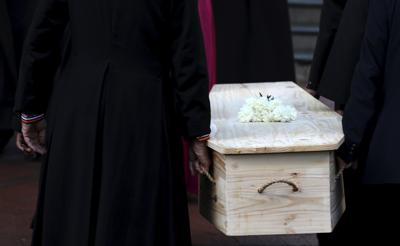 The coffin carrying Anglican Archbishop Emeritus Desmond Tutu is carried into the St. George's Cathedral Friday, Dec. 31, 2021 where he will lie in state for a second day in Cape Town, South Africa. Tutu, the Nobel Peace Prize-winning activist for racial equality and LGBT rights died Sunday at the age of 90. (AP Photo/Nardus Engelbrecht)