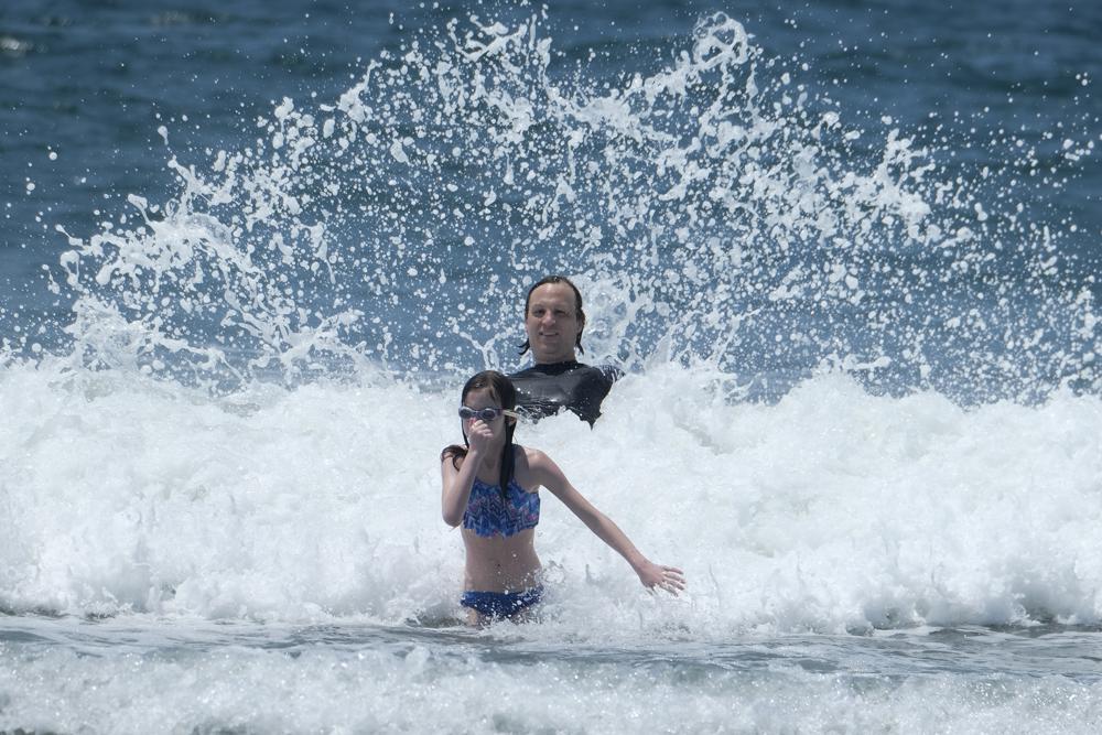 People play in the water in the heat at Santa Monica Beach on Wednesday, June 16, 2021, in Santa Monica, Calif. (AP Photo/Ringo H.W. Chiu)