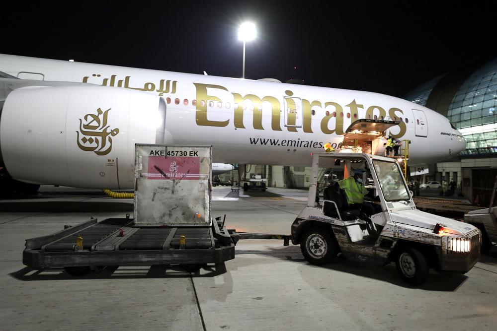 FILE - A shipment is offloaded from an Emirates Airlines Boing 777 at the Dubai International Airport in Dubai, United Arab Emirates on Feb. 21, 2021. Long-hauled carrier Emirates is buying five Boeing 777 freighters in a deal valued at more than $1.7 billion, further expanding its cargo flight capacity, the two companies announced Tuesday, Nov. 8, 2022. (AP Photo/Kamran Jebreili, File)