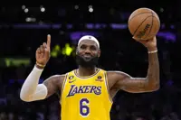 Los Angeles Lakers forward LeBron James gestures after passing Kareem Abdul-Jabbar to become the NBA's all-time leading scorer during the second half of an NBA basketball game against the Oklahoma City Thunder Tuesday, Feb. 7, 2023, in Los Angeles. (AP Photo/Ashley Landis)