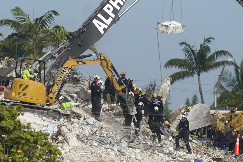 Rescue crews work at the site of the collapsed Champlain Towers South condo building after the remaining structure was demolished Sunday, in Surfside, Fla., Monday, July 5, 2021. Many people are unaccounted for in the rubble of the building which partially collapsed June 24. (AP Photo/Lynne Sladky)