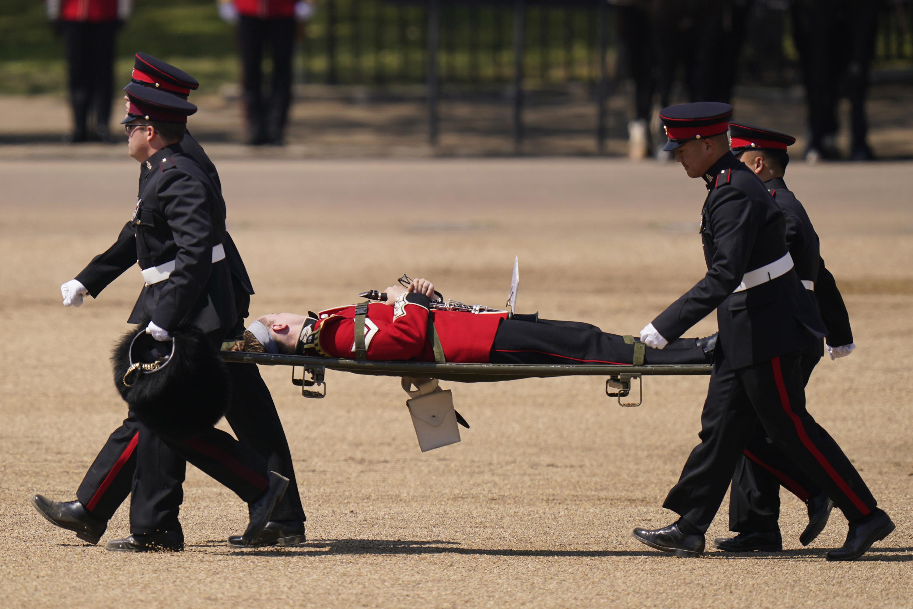 Troops feel the heat, and several faint, as Prince William reviews military  parade