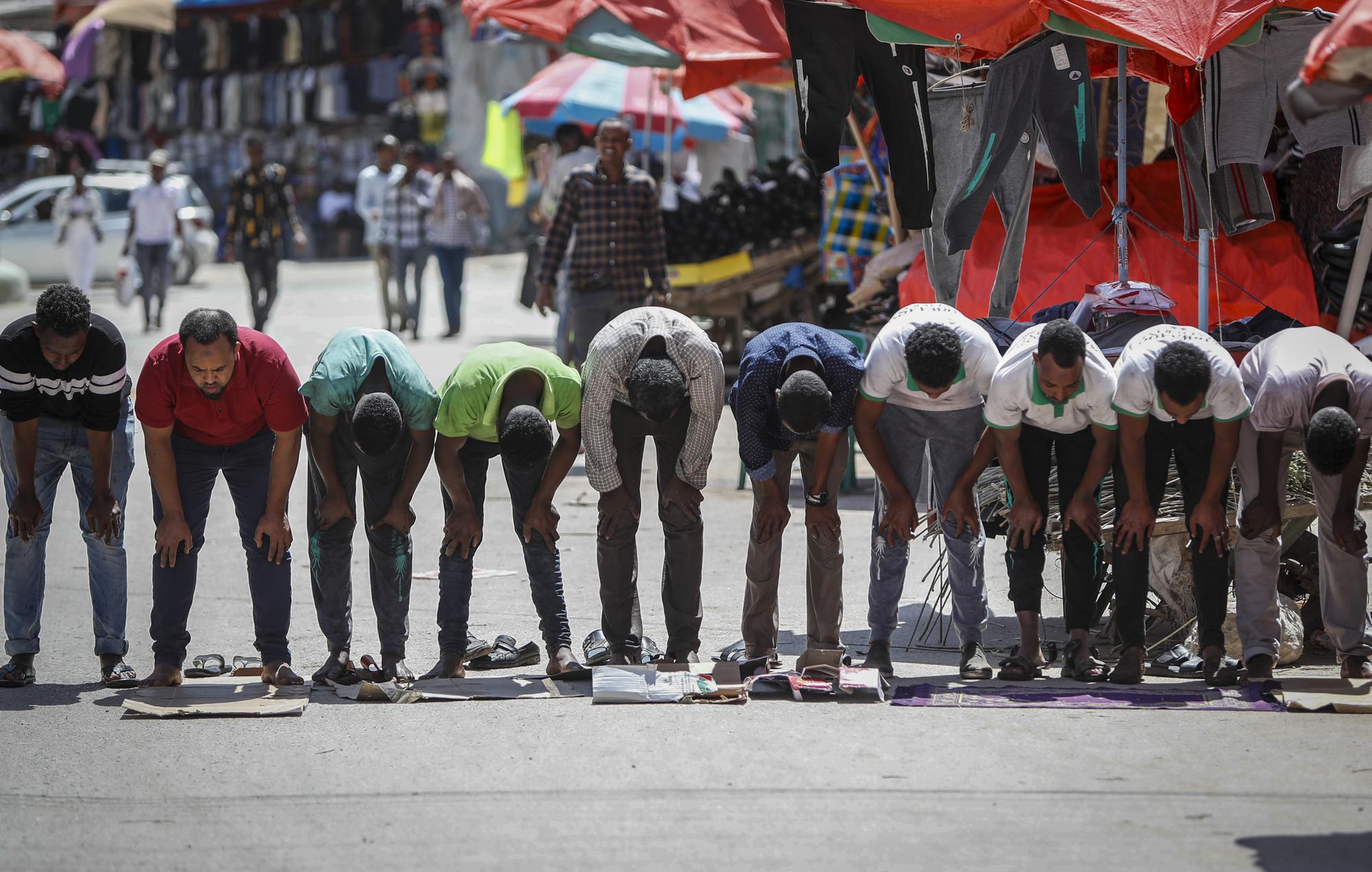 Muslims make Friday prayers on the street in Hargeisa, Somaliland, a semi-autonomous breakaway region of Somalia, Friday, Feb. 11, 2022. Officials and health workers say cases of female genital mutilation increased during the pandemic in parts of Africa and particularly in Somaliland where 98 percent of girls aged 5 to 11 undergo the procedure. (AP Photo/Brian Inganga)