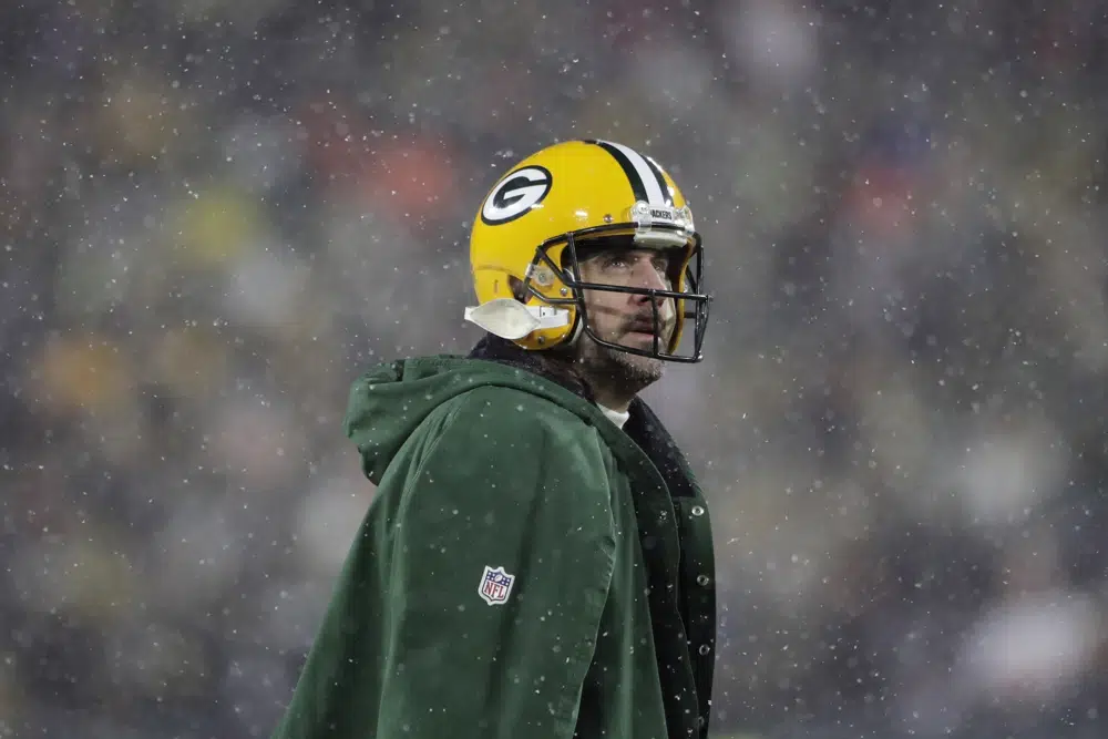 FILE - Green Bay Packers' Aaron Rodgers looks up during the second half of an NFC divisional playoff NFL football game against the San Francisco 49ers, Jan. 22, 2022, in Green Bay, Wis. Rodgers is leaving behind his brilliant legacy in Green Bay and heading to the bright lights — and massive expectations — of the Big Apple. The New York Jets agreed on a deal Monday, April 24, 2023, to acquire the four-time NFL MVP from the Packers, according to a person with knowledge of the trade. The person spoke to The Associated Press on the condition of anonymity because the teams have not officially announced the deal. (AP Photo/Aaron Gash, File)