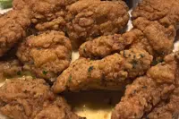 An order of "boneless chicken wings" rests on a plate, Tuesday, Feb. 7, 2023, in Derry, N.H. With the Super Bowl at hand, behold the cheerful untruth that has been perpetrated upon (and generally with the blessing of) the chicken-consuming citizens of the United States on menus across the land: a “boneless wing” that isn’t a wing at all. (AP Photo/Charles Krupa)