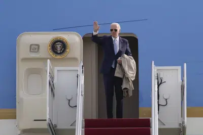 President Joe Biden waves as he stands at the top of the stairs before boarding Air Force One at Andrews Air Force Base, Md., Sunday, Jan. 8, 2023. Biden is traveling to El Paso, Texas, and then on to Mexico City, Mexico. (AP Photo/Carolyn Kaster)
