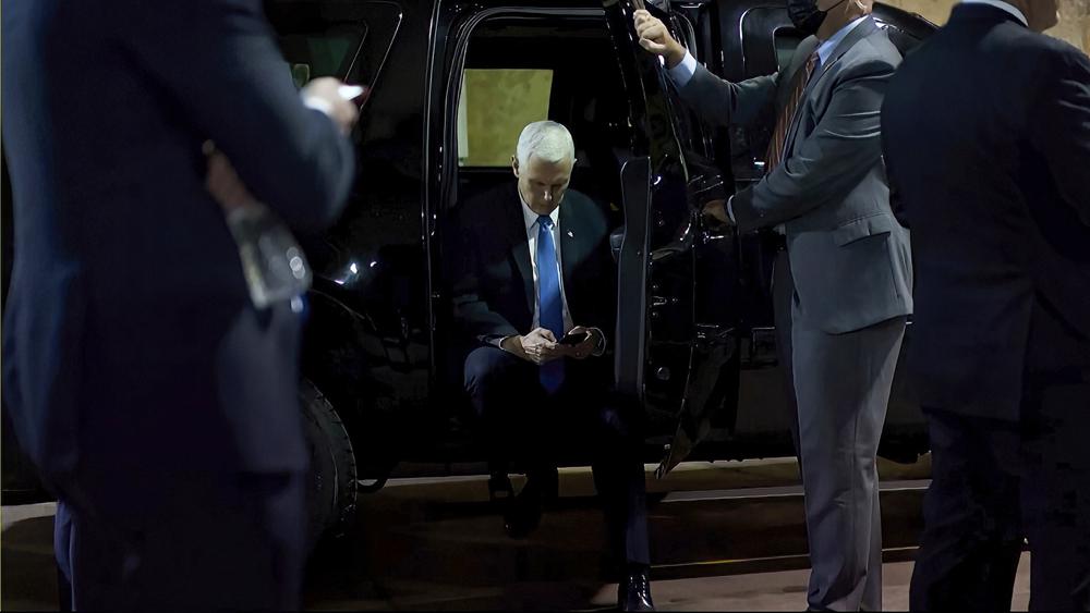 In this image from video released by the House Select Committee, Vice President Mike Pence looks at a phone from his secure evacuation location on Jan. 6 that is displayed as House select committee investigating the Jan. 6 attack on the U.S. Capitol holds a hearing Thursday, June 16, 2022, on Capitol Hill in Washington. (House Select Committee via AP)