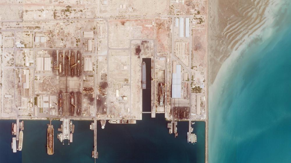 This satellite photo from Planet Labs PBC shows the Iranian Revolutionary Guard's newest ship, the Shahid Mahdavi, center right, under construction in a shipyard west of Bandar Abbas, Iran, Saturday, May 21, 2022. Iran's paramilitary Revolutionary Guard is building the massive new support ship near the strategic Strait of Hormuz as it tries to expand its naval presence in waters vital to international energy supplies and beyond, satellite photos obtained by The Associated Press show. (Planet Labs PBC via AP)