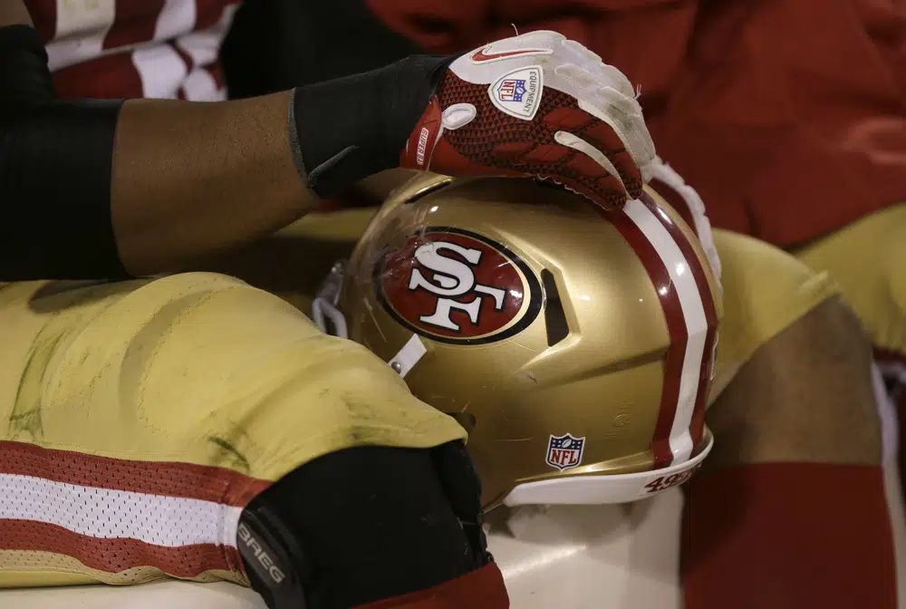 FILE A San Francisco 49ers player sits on the bench during the second half of an NFL preseason football game against the San Diego Chargers in San Francisco, Thursday, Aug. 30, 2012. The San Francisco 49ers have reached an agreement to take over English soccer club Leeds with NBA players Larry Nance Jr. and T.J. McConnell joining the ownership group as minority investors. (AP Photo/Marcio Jose Sanchez, File)