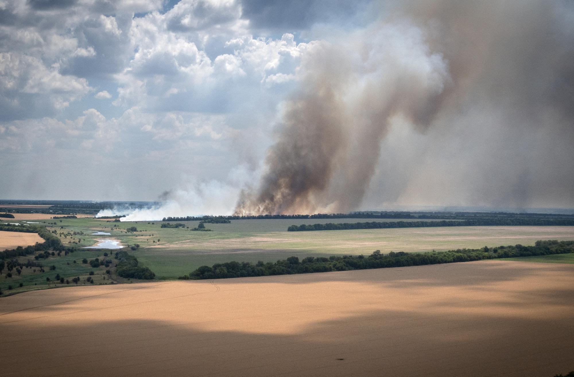 FILE - Smoke rises from the front lines between Ukrainian and Russian troops, with a farm in the foreground in the Dnipropetrovsk region of Ukraine, Monday, July 4, 2022. (AP Photo/Efrem Lukatsky, File)