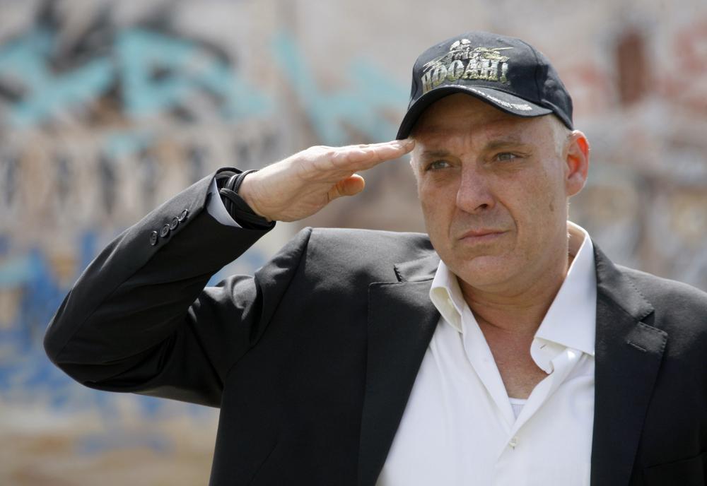 FILE - Actor Tom Sizemore salutes in honor of Memorial Day, a day early, at the Mexican-American All Wars Memorial in Los Angeles, Sunday, May, 29, 2011. Sizemore, the “Saving Private Ryan” actor whose bright 1990s star burned out under the weight of his own domestic violence and drug convictions, died Friday, March 3, 2023, at age 61. (AP Photo/Nick Ut, File)