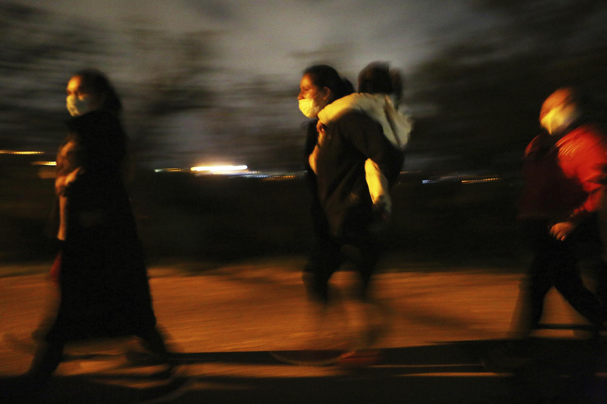 FILE - Migrants walk to be processed by the U.S. Border Patrol after crossing the Rio Grande on May 14, 2021, in Roma. Texas. Biden took office on Jan. 20 and almost immediately, numbers of migrants exceeded expectations. (Joel Martinez/The Monitor via AP, File)