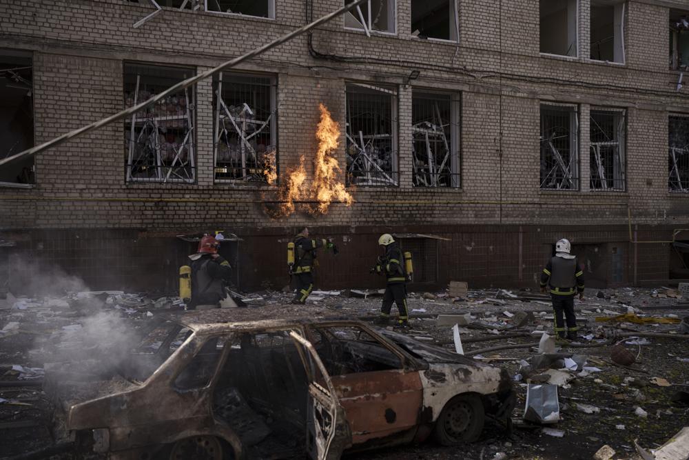 Firefighters work to extinguish multiple fires after a Russian attack in Kharkiv, Ukraine, Saturday, April 16, 2022. (AP Photo/Felipe Dana)