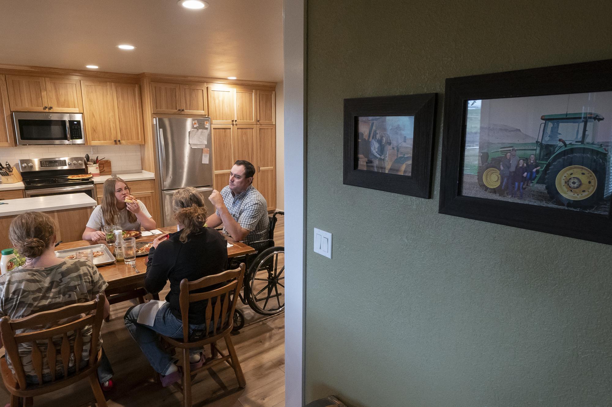 The DuVal family eats dinner together in their farmhouse on Wednesday, June 9, 2021, in Tulelake, Calif. Ben DuVal said he worries the continued water shortage will prevent him from passing on their farming way of life to his kids. DuVal's family has farmed the land near the California-Oregon border for three generations, and this summer for the first time ever, he and hundreds of others who rely on irrigation from a depleted, federally managed lake aren't getting any water from it at all. (AP Photo/Nathan Howard)