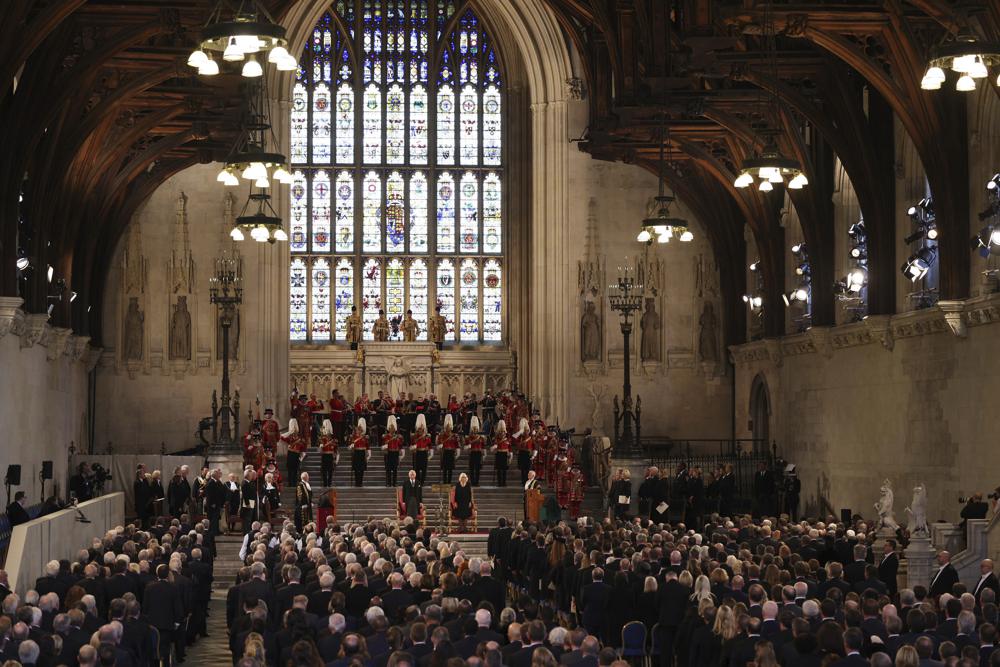 King Charles III and Camilla, the Queen Consort stand in Westminster Hall, where both Houses of Parliament met to express their condolences, following the death of Queen Elizabeth II, in London, Monday, Sept. 12, 2022. Queen Elizabeth II, Britain's longest-reigning monarch and a rock of stability across much of a turbulent century, died Thursday Sept. 8, 2022, after 70 years on the throne. She was 96. (Dan Kitwood/Pool Photo via AP)
