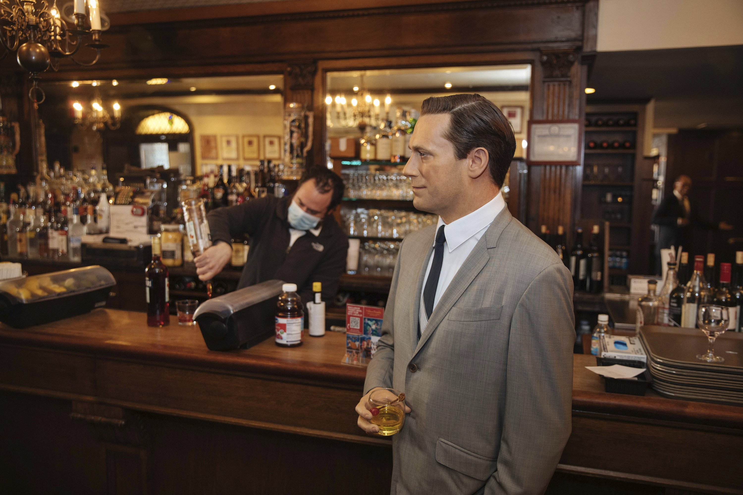 A wax Don Draper hanging from the bar