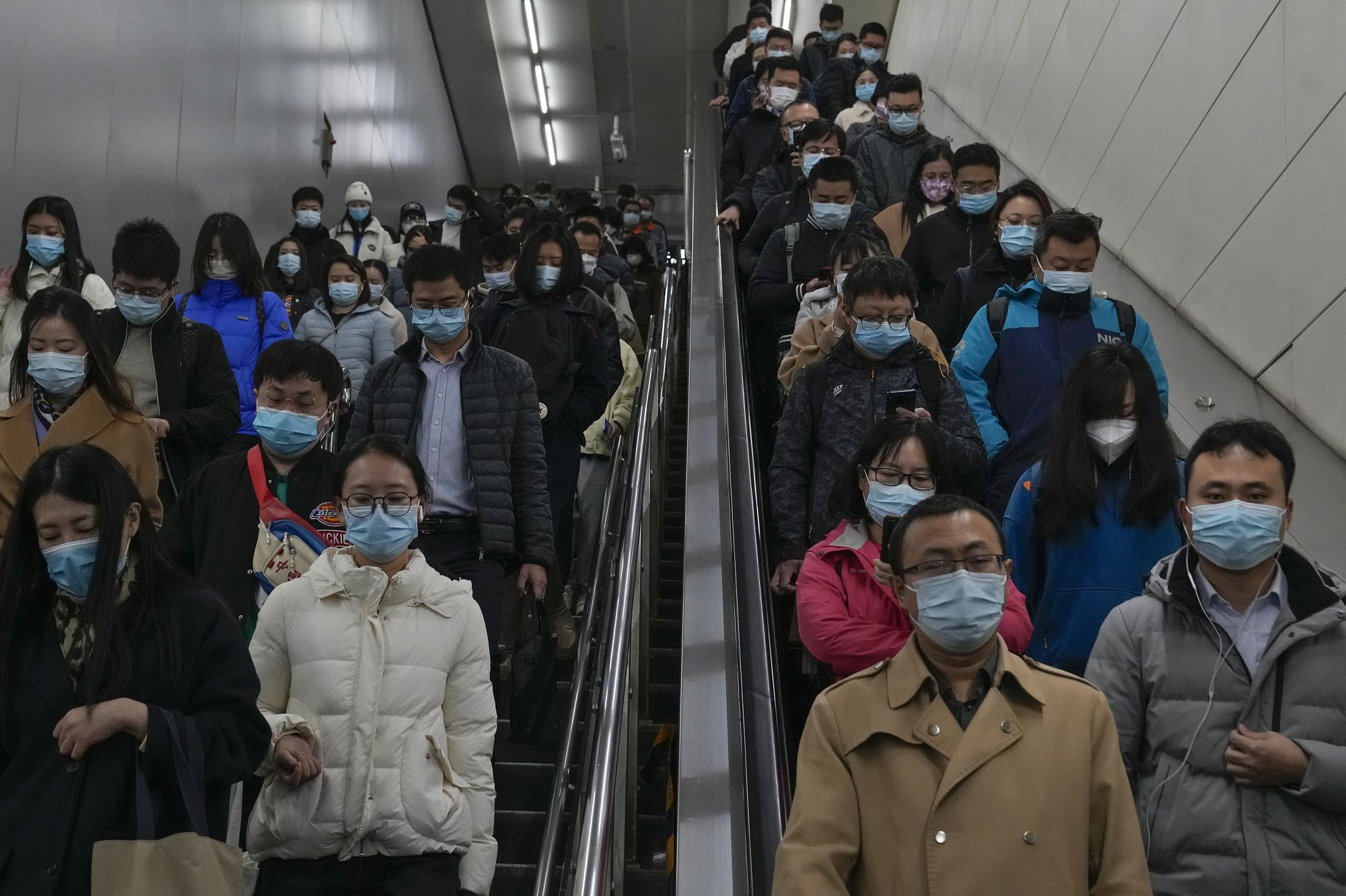 Commuters rush to catch their trains at a subway station during the morning rush hour in Beijing on Monday, Nov. 14, 2022. The world's population is projected to hit an estimated 8 billion people on Tuesday, Nov. 15, according to a United Nations projection.  (AP Photo/Andy Wong)