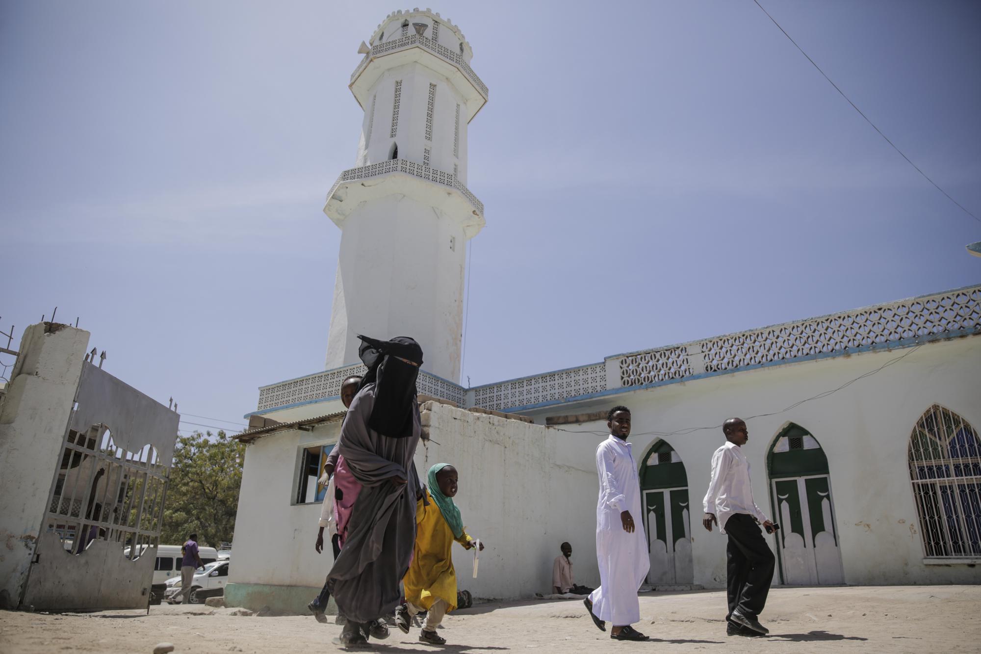 A female worshipper enters to make Friday Muslim prayers at a mosque in Hargeisa, Somaliland, a semi-autonomous breakaway region of Somalia, Friday, Feb. 11, 2022. Officials and health workers say cases of female genital mutilation increased during the pandemic in parts of Africa and particularly in Somaliland where 98 percent of girls aged 5 to 11 undergo the procedure. (AP Photo/Brian Inganga)