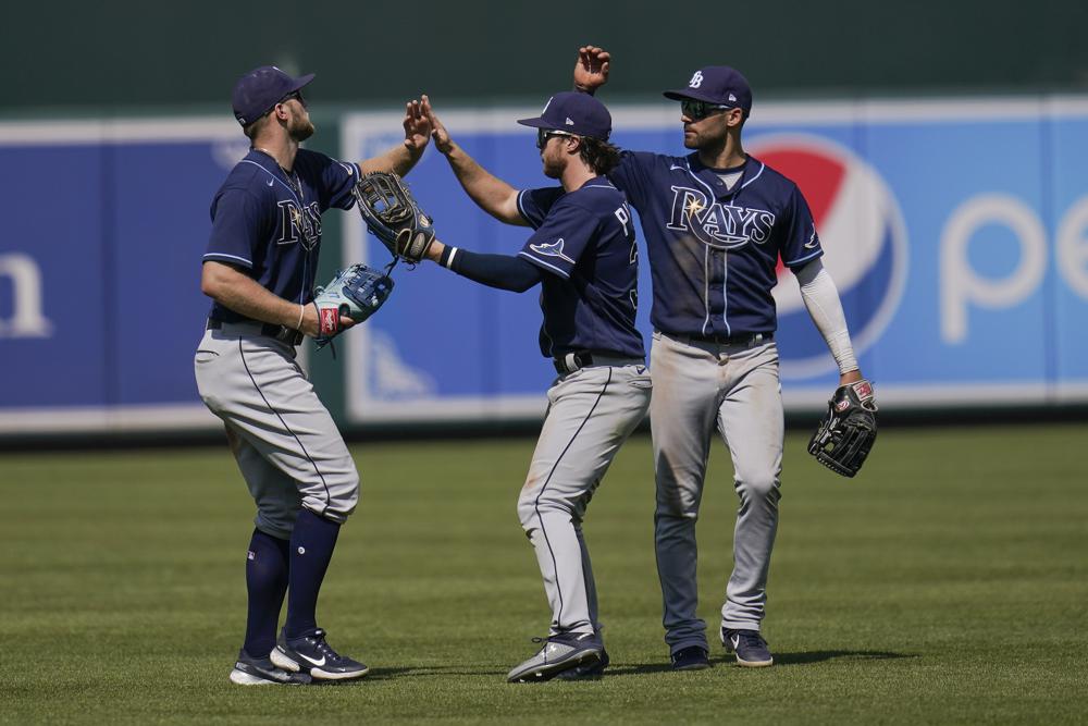 Tampa Bay Rays outfielders Austin Meadows, left, Brett Phillips, center, and Kevin Kiermaier celebrate after defeating the Baltimore Orioles during a baseball game, Thursday, May 20, 2021, in Baltimore. The Rays won 10-1. (AP Photo/Julio Cortez)