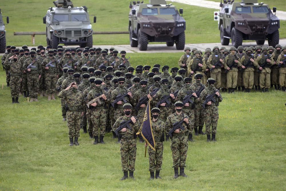 In this photo provided by the Serbian Defense Ministry, Russian and Serbian soldiers perform during exercise in Deliblatska Pescara, a large sand area, 70 kilometers north-west of Belgrade, Serbia. Serbia and Russia on Thursday launched joint military exercise in the Balkan country as the US-led forces held massive drills in neighboring states in what appeared to be Moscow's resolve to maintain influence in the European region torn by wars in the 1990s. (Serbian Defense Ministry Press Service via AP)