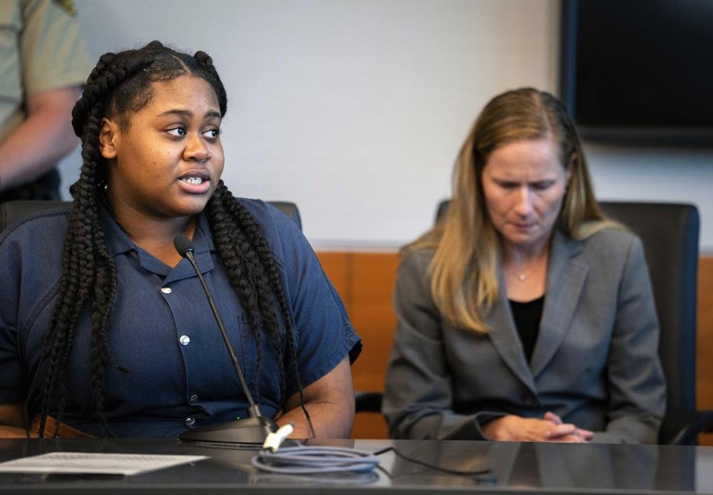 Pieper Lewis, left, speaks with Polk County District Judge David M. Porter during her sentencing hearing, Tuesday, Sept. 13, 2022. Lewis, who was initially charged with first-degree murder after she stabbed her accused rapist to death in June 2020, was sentenced to five years of closely supervised probation and ordered to pay $150,000 restitution to the man’s family. (Zach Boyden-Holmes/The Des Moines Register via AP)