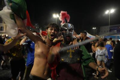 Italy's fans celebrate in Rome, Monday, July 12, 2021, after Italy beat England to win the Euro 2020 soccer championships in a final played at Wembley stadium in London. Italy beat England 3-2 in a penalty shootout after a 1-1 draw. (AP Photo/Gregorio Borgia)