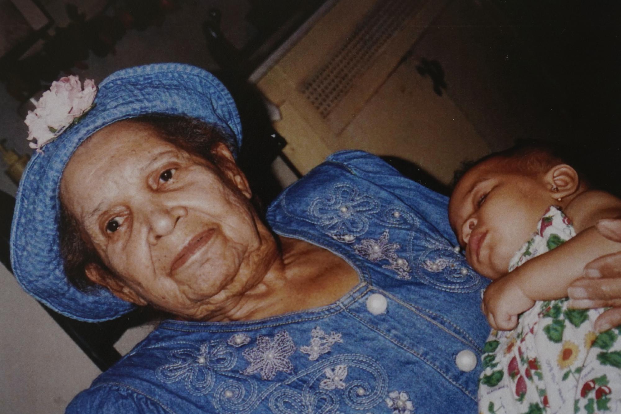 In this undated photo provided by Carolyn Roberts of the Gibbs family in April 2021, Tulsa Race Massacre survivor Ernestine Alpha Gibbs holds one of her grandchildren, DeShayla Roberts, two decades earlier. (Courtesy Carolyn Roberts via AP)