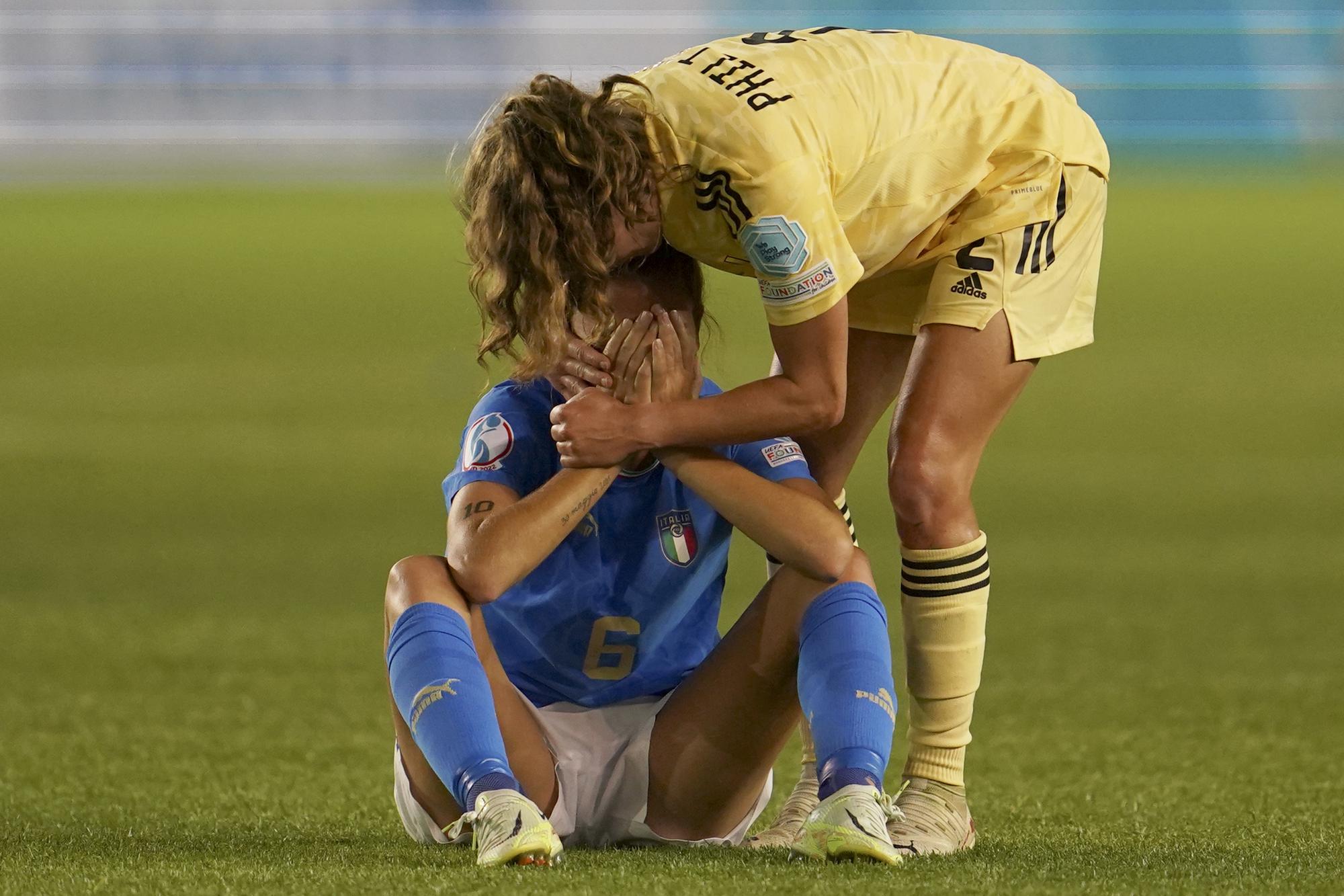 FILE - Belgium's Davina Philtjens comforts Italy's Manuela Giugliano sitting on the ground at the end of the Women Euro 2022 group D soccer match between Italy and Belgium at the Manchester City Academy Stadium, in Manchester, England, Monday, July 18, 2022. Belgium won 1-0 to advance to the quarterfinals. (AP Photo/Jon Super, File)