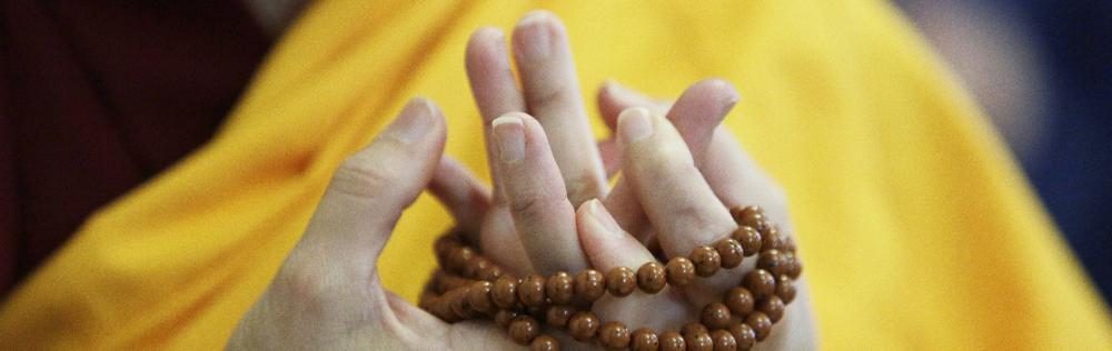 **HOLD FOR STORY**Thubten Nyima, a fully ordained Buddhist nun, holds beads during a chant at Sravasti Abbey, Thursday, Nov. 18, 2021, in Newport, Wash. (AP Photo/Young Kwak)